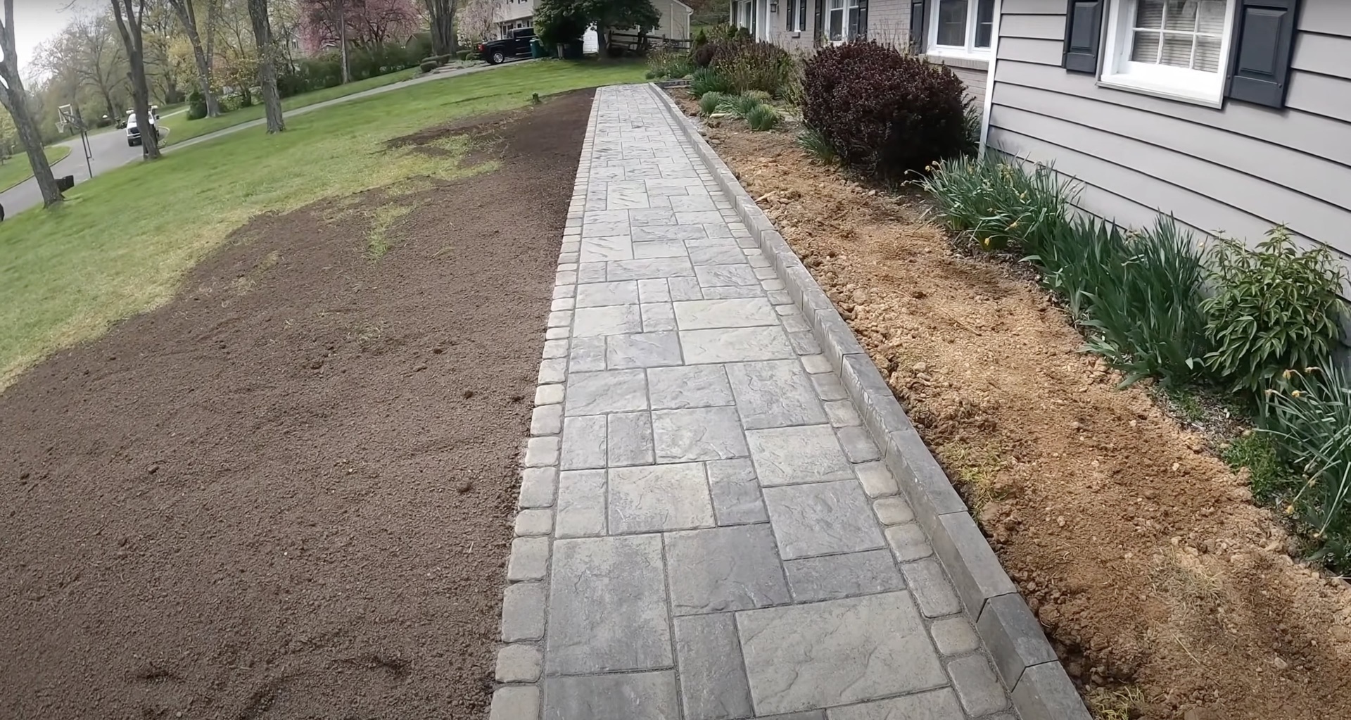 Stamped concrete walkway construction by Haltom City Concrete - Natural stone pattern finish Professional stamped concrete walkway installation with natural stone pattern and clean edges