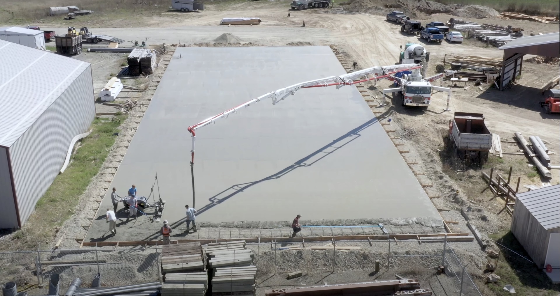 Commercial concrete slab installation by Haltom City Concrete - Large-scale concrete pouring with pump truck Large-scale commercial concrete slab installation with concrete pump truck and professional crew