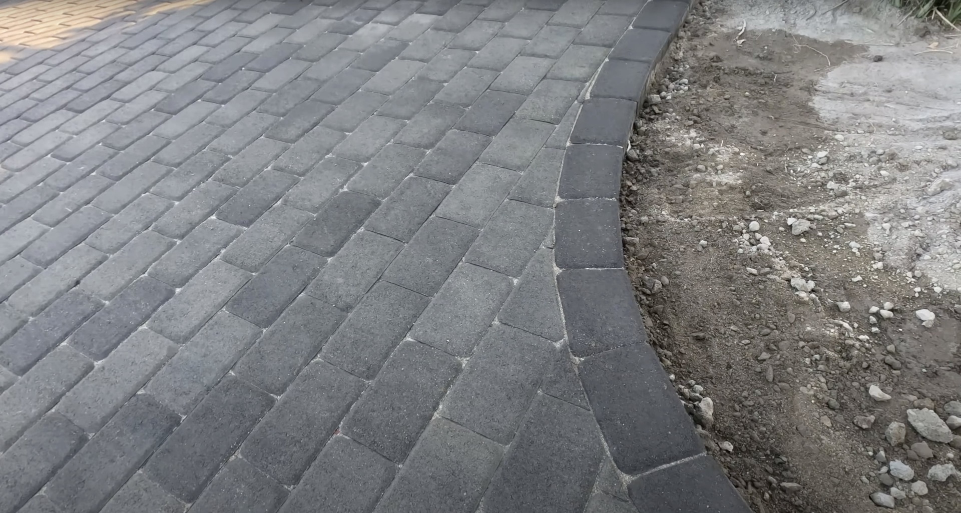 Professional concrete paver work by Haltom City Concrete - Interlocking paver installation with clean edges High-quality concrete paver installation with interlocking pattern and professional edge finishing