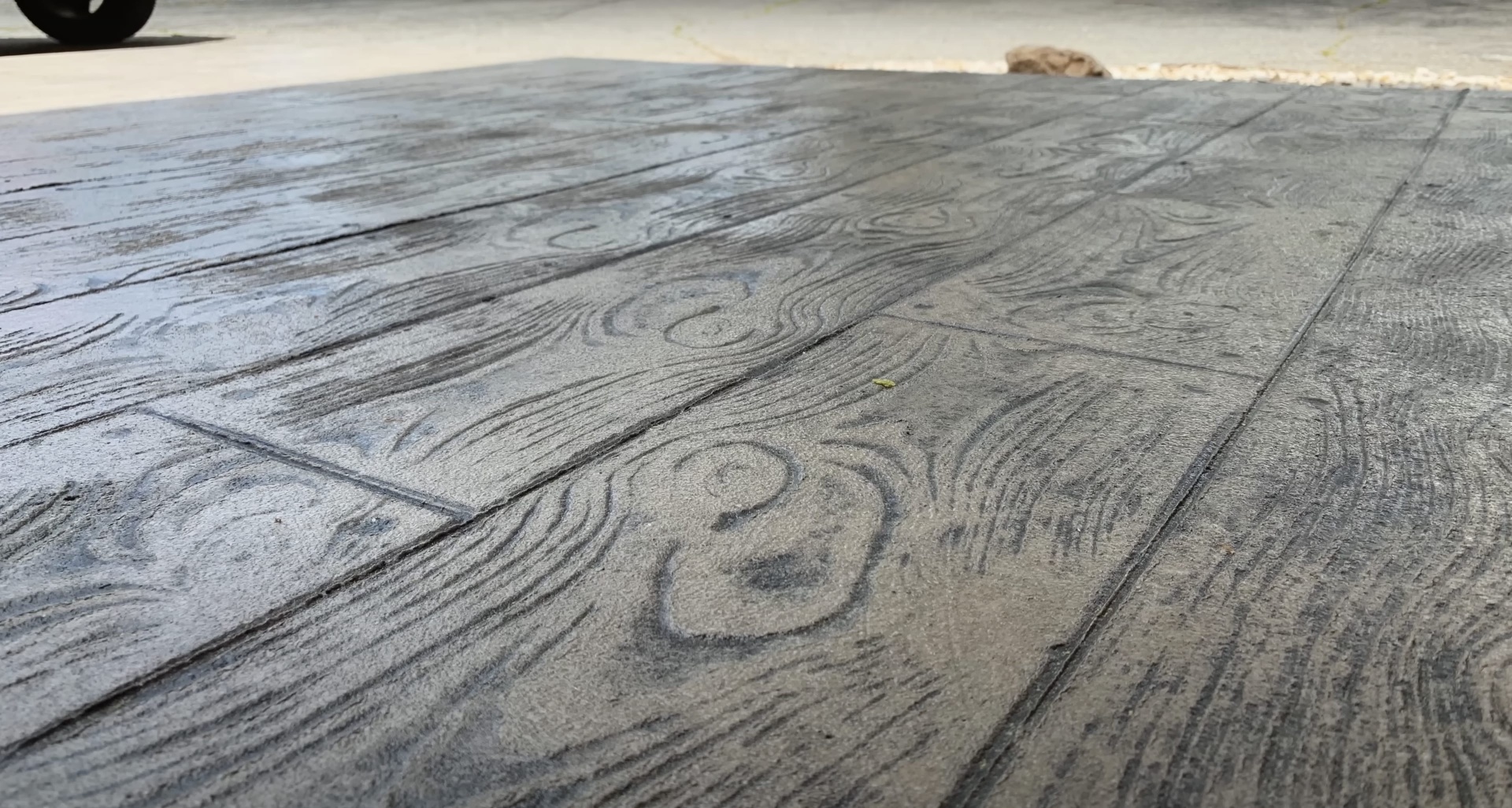 Decorative stamped concrete installation by Haltom City Concrete - Wood grain pattern finish Beautiful stamped concrete with wood grain pattern showing detailed texture and craftsmanship